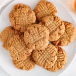 View on sourdough peanut butter cookies on a plate garnished with sea salt.