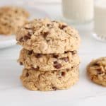 A few vegan sourdough oatmeal cookies piled over each other.