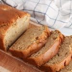 Sliced loaf of vegan sourdough apple cinnamon bread on a cutting board.