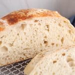 Half sliced easy no knead sourdough bread to show the middle crumb.