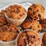 Pile of vegan pumpkin banana muffins on a plate.