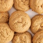 Vegan brown sugar cookies freshly baked on parchment paper.