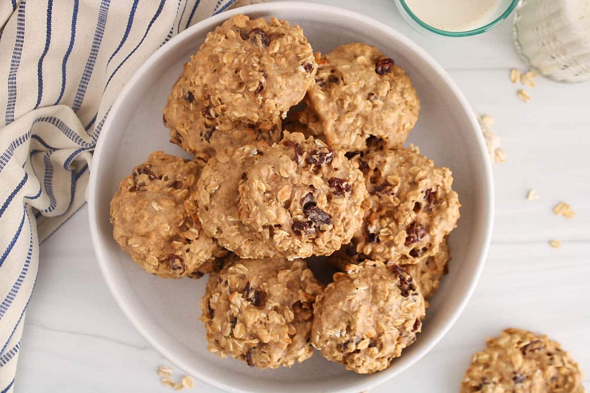 A plate filled with Vegan Oat and Raisin Protein Cookies.