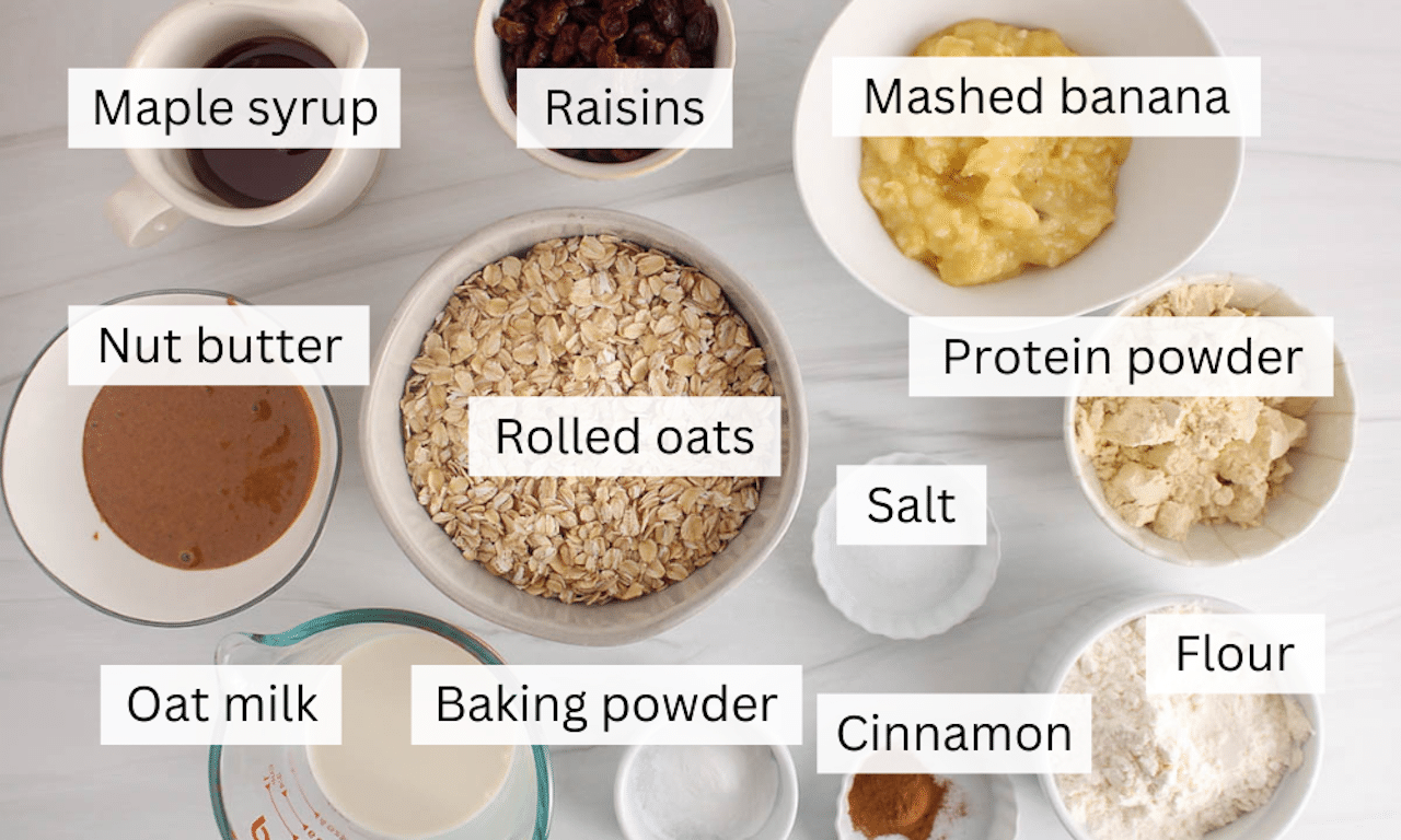 Ingredients to make Vegan Oat and Raisin Protein Cookies placed on a white surface.