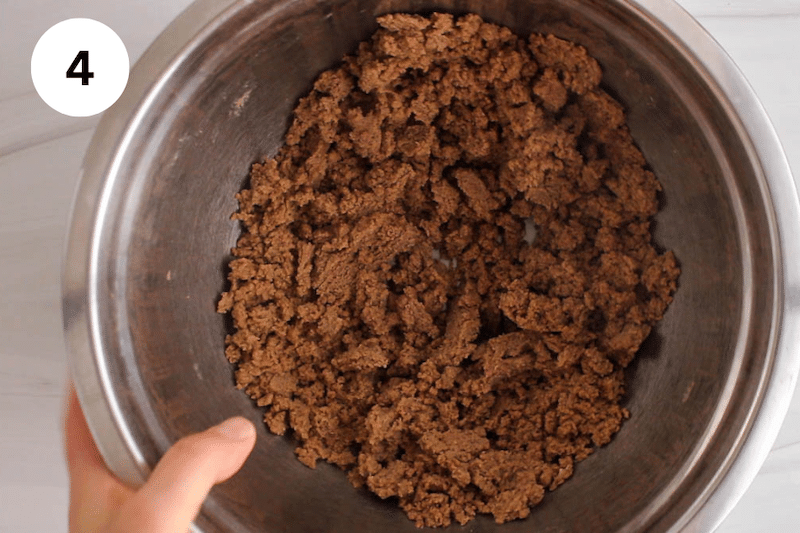 A mixing bowl with a cinnamon crumbly filling.