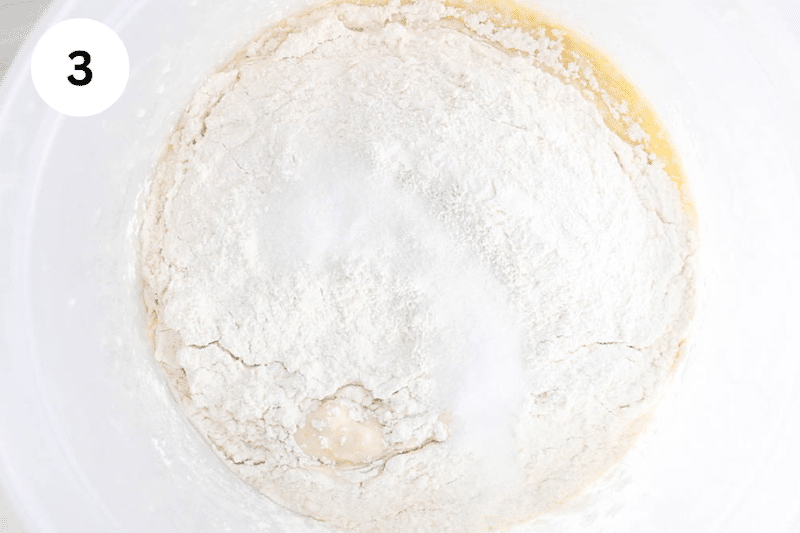 A large container with flour and leavening agents.