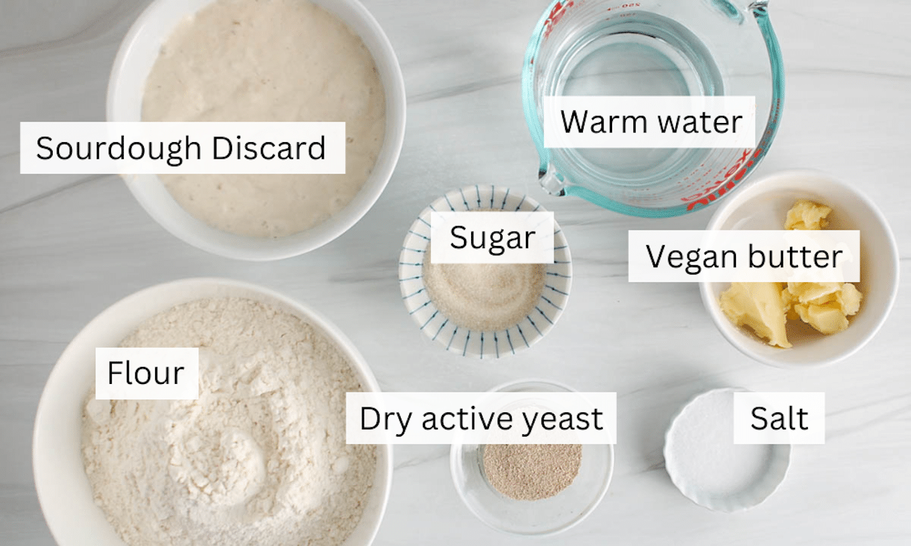 Showing are the ingredients needed to make sourdough discard soft rolls.