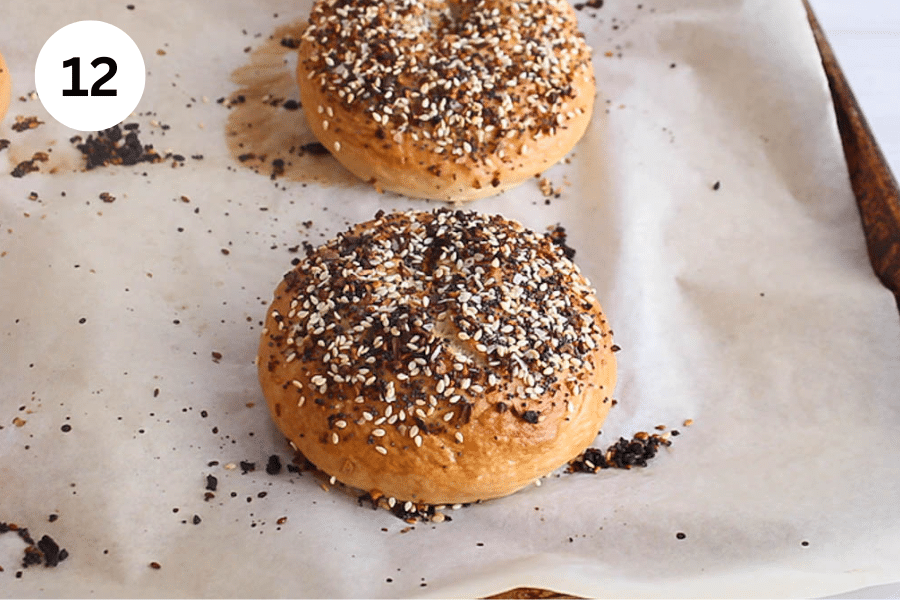A baking sheet with freshly baked everything bagels.