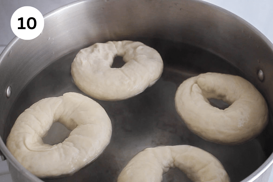A large pot of water simmering bagels.