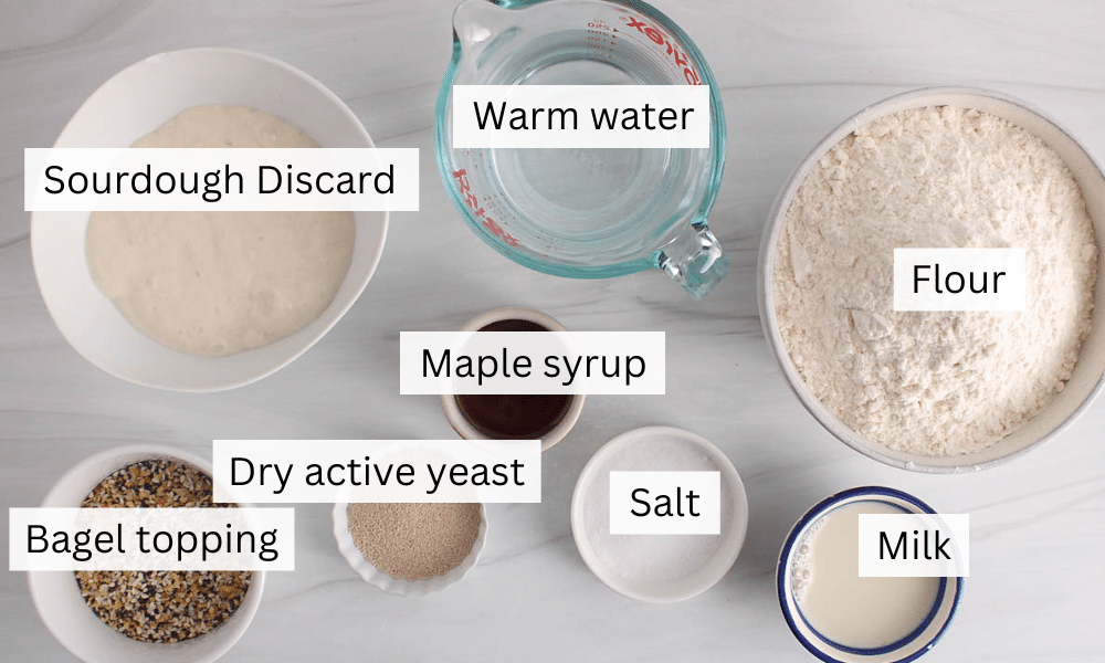 Ingredients needed to make sourdough discard bagels placed on a table.