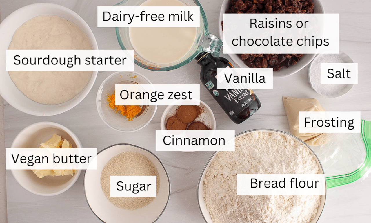 Ingredients to make sourdough hot cross buns on a table.
