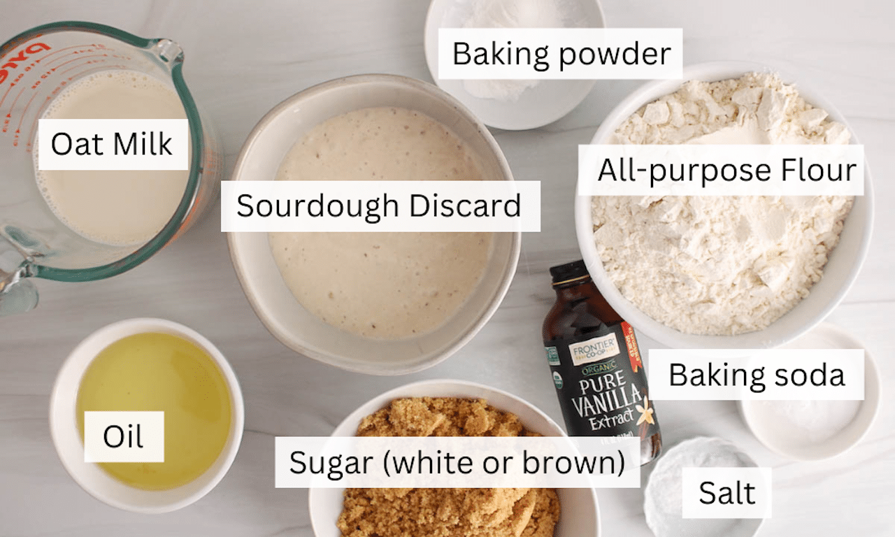 Ingredients to make sourdough vanilla cake placed on a white table.