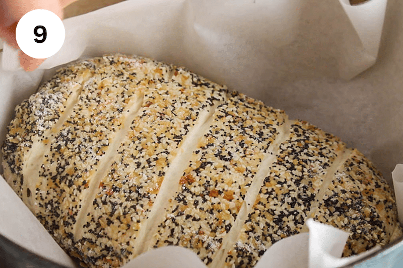 A scored dough in a Dutch oven.