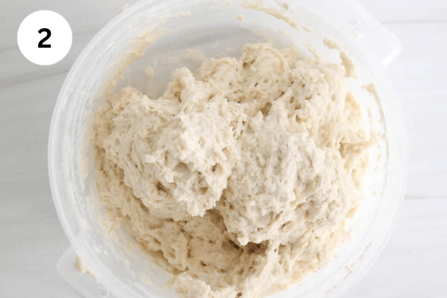 A large container with a shaggy dough.