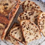 Sliced chocolate chips sourdough bread over a cooling rack.