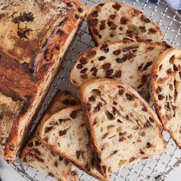 Sliced chocolate chips sourdough bread over a cooling rack.