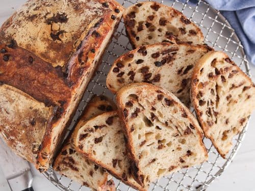 Sliced chocolate chips sourdough bread over a cooling rack.
