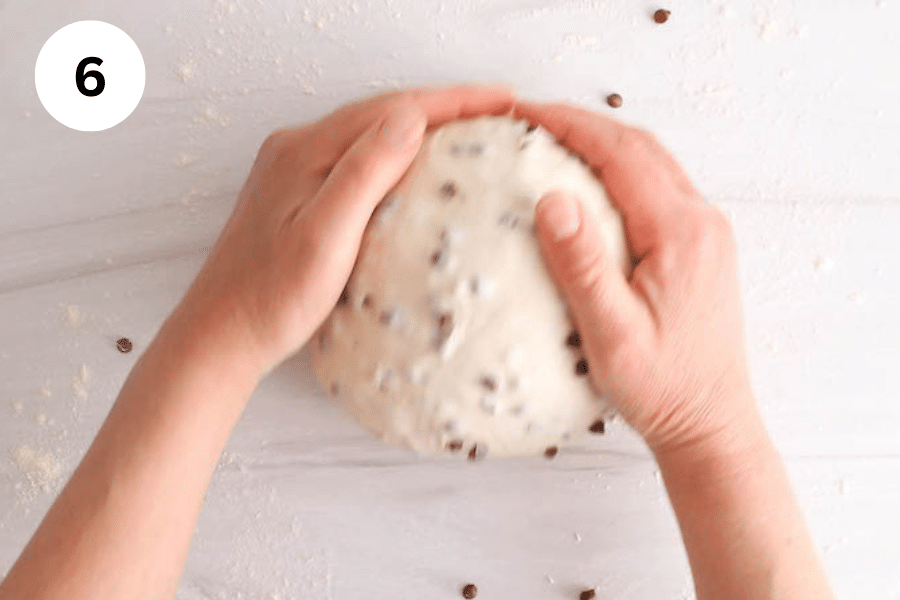 Hand shaping some dough into a balls.